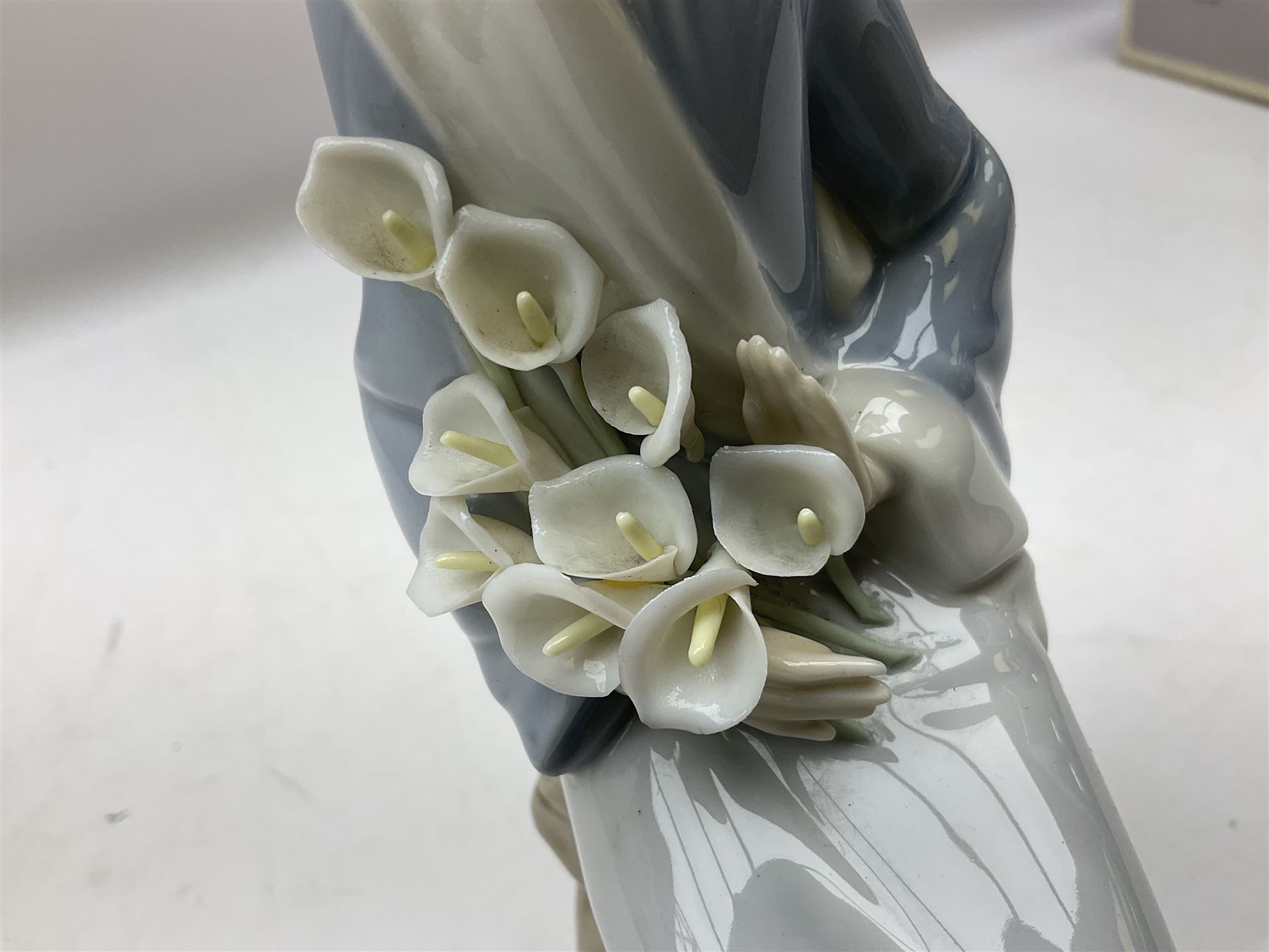 Four Lladro figures, comprising Afternoon Promenade no 7636, Nostalgia no 5071, both with original boxes, Girl with Lilies no 4972 and Madonna no 4534, largest example H27cm