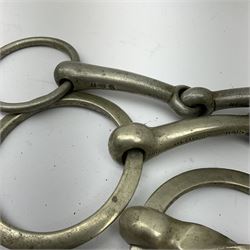 Horse riding - seventeen nickel horse bits, two pairs of stirrups and four pairs of nickel spurs