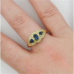 18ct gold three stone oval and pear cut sapphire ring, with diamond set surround