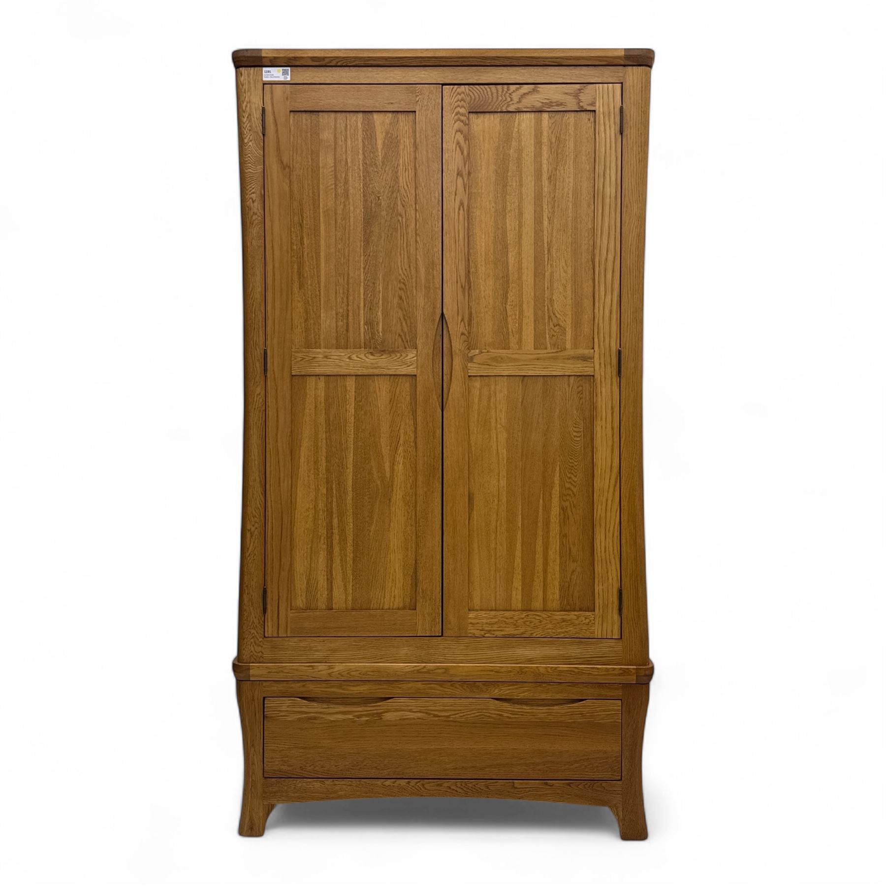 Modern light oak double wardrobe, with twin panelled doors enclosing hanging rail and full-height interior, above a deep lower drawer with recessed handle, shaped stiles