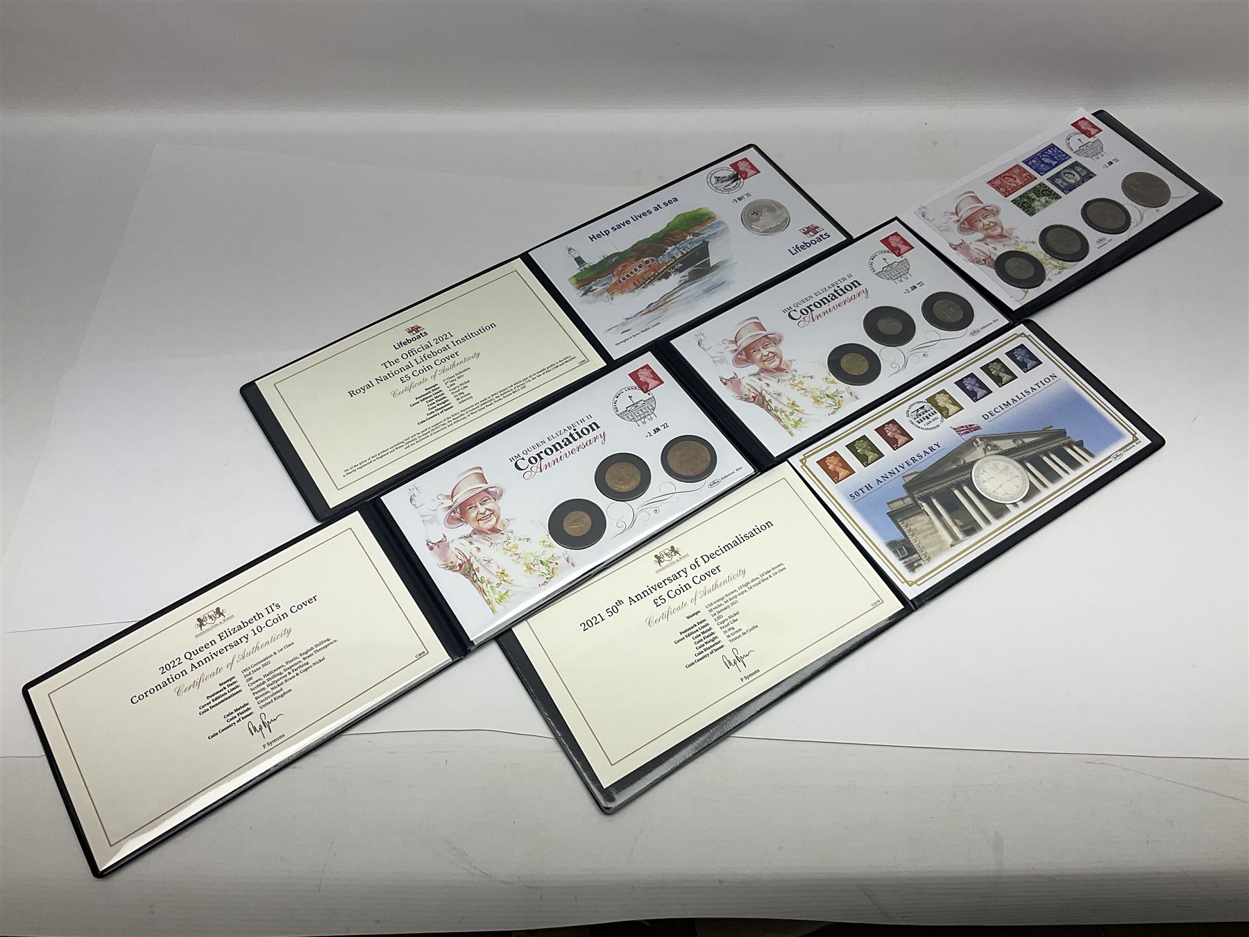 Commemorative coins and covers, including '80th Anniversary of the Battle of Britain' coin cover with Solomon Islands 2020 half dollar, 'Royal National Lifeboat Institution' coin cover with Alderney 2021 five pounds, 'Queen Elizabeth II's 95th Birthday' coin cover with Solomon Islands 2021 half dollar, other similar coin covers all in Harrington and Byrne folders, The Royal Mail 'HM The Queen's 95th Birthday' coin cover with 2021 five pounds and Queen Elizabeth II Isle of Man 2020 'Peter Pan' fifty pence coin collection in card folder
