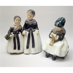Two Royal Copenhagen figures, the first example a figure group of two Armager girls holding hands, model no 1316, H18.5cm, the second an Armager girl knitting, model no 1314, H14.5cm.