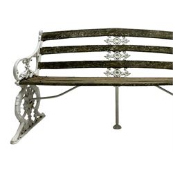 Late 19th century white painted cast iron and wood slatted garden bench, the bench ends in the form of S-scroll mythical beasts with paw feet, central cartouche surrounded by extending trailing foliage, the back slats divided by scroll cast splats, central seat support 