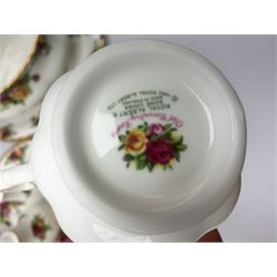 Royal Albert Country Roses part dinner service comprising a coffee pot, three dinner plates, two oval bowls, six breakfast bowls, three larger bowls, oval platter, salt and pepper pots, sauce boat and stand, teacup and stand, serving plate and two tea plates