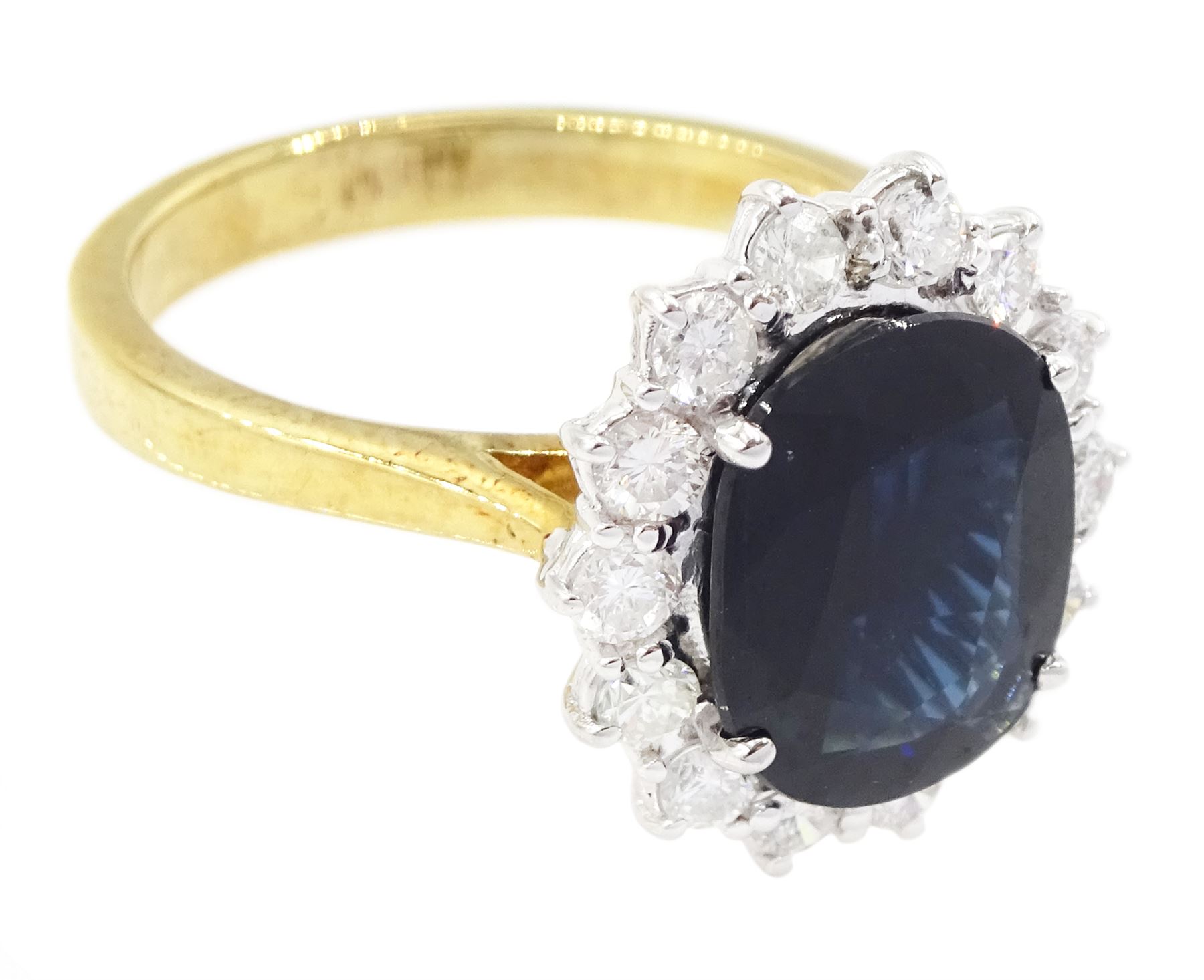 18ct gold oval cut sapphire and round brilliant cut diamond cluster ring, sapphire approx 3.30 carat, total diamond weight approx 0.85 carat