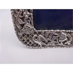 Victorian silver mounted photograph frame, of rectangular form, with bead and dart rim, pierced and embossed green man mask, lattice, bird and foliate decoration and engraved cartouche to top centre, with easel style support verso, hallmarked William Comyns & Sons, London 1898
