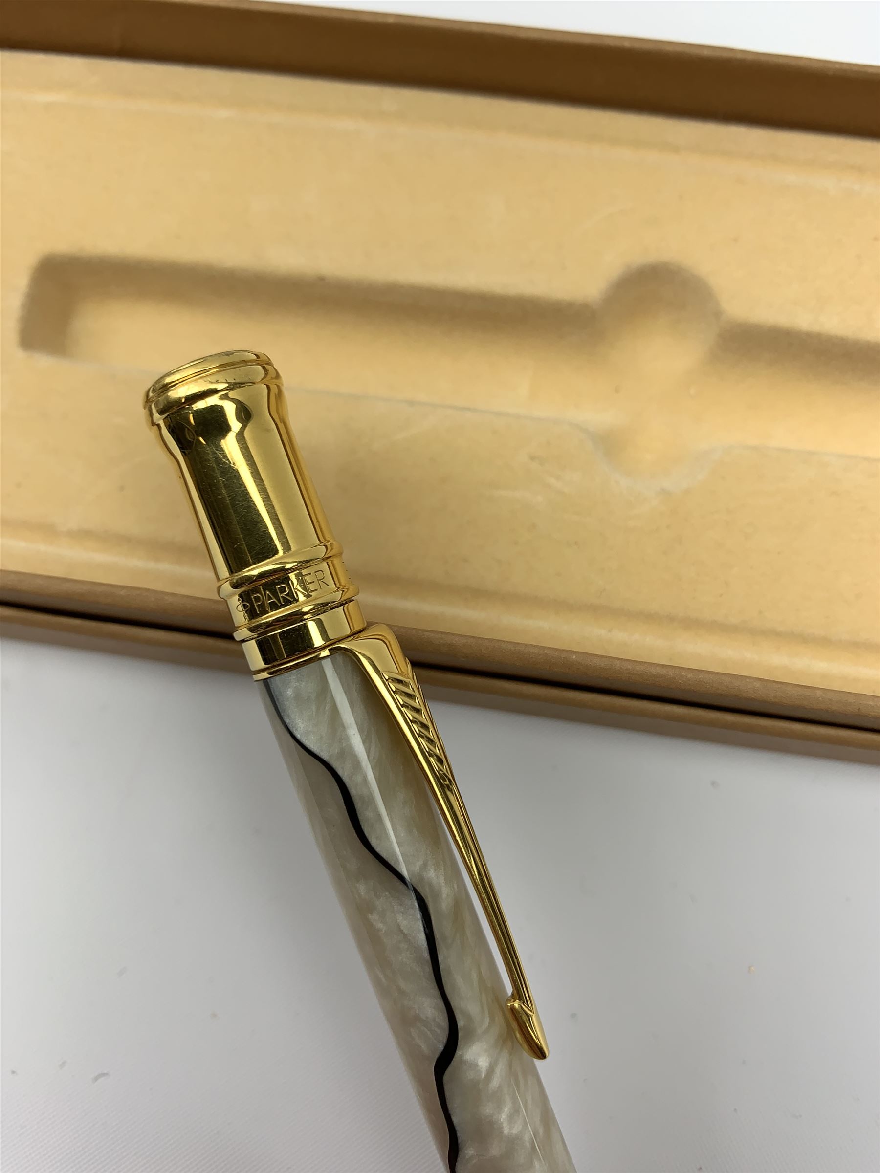 A group of pens, comprising Parker Duofold Centennial pearl and black ballpoint pen, Parker Frontier ballpoint pen, Ronson Penciliter, in original box, Parker Rialto fountain pen, and a further unmarked ballpoint. (5). 