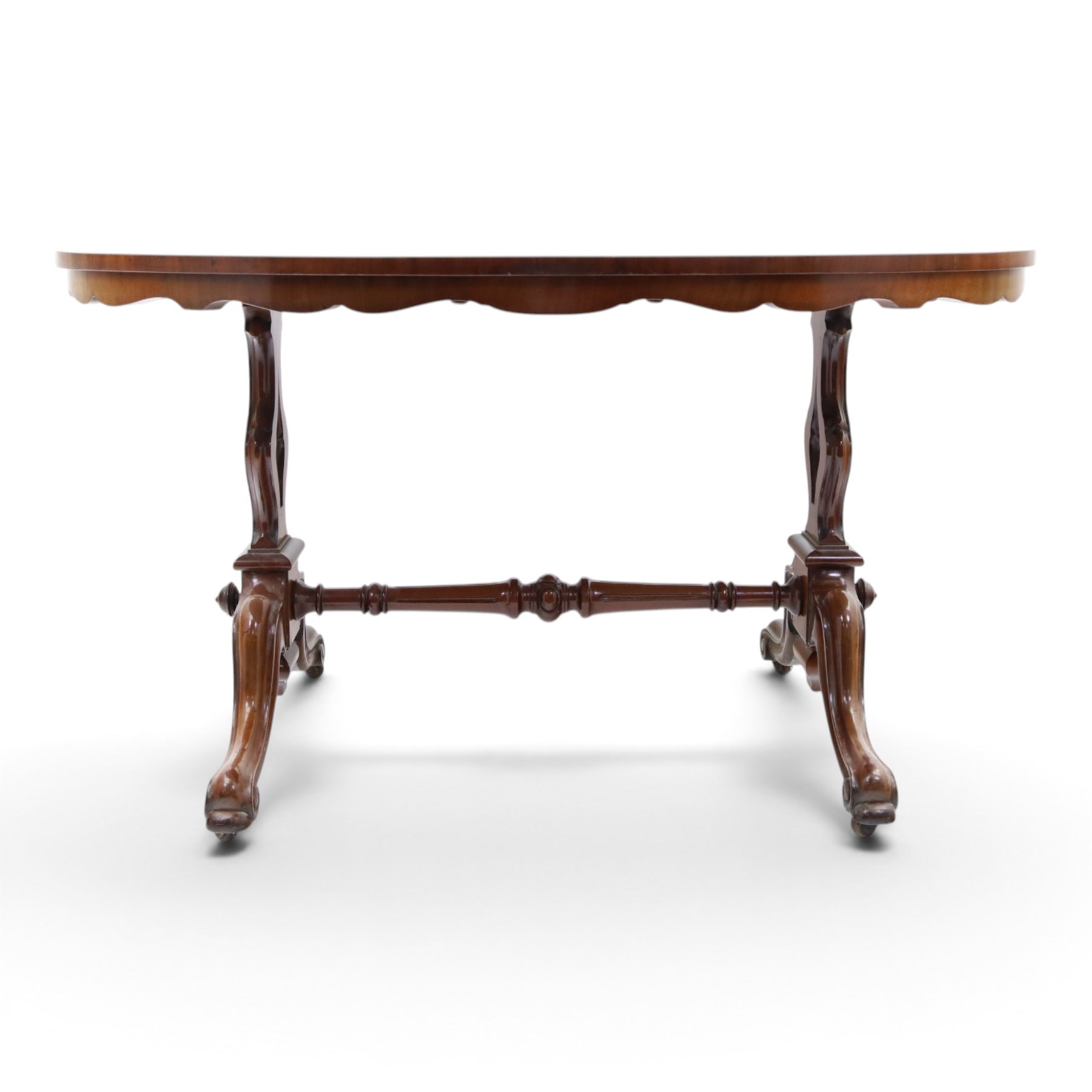 Victorian mahogany breakfast table, oval moulded top over a shaped frieze, on twin pierced lyre-form end supports with moulded scroll feet, united by a turned stretcher, on castors