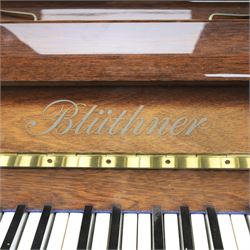 Bluthner of Leipzig upright piano, mahogany case with 88 keys and three brass pedals