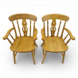 Solid oak dining table and set of seven pine farmhouse chairs including two carvers, rectangular top with tongue and groove style finish, supported a 'H' stretcher with square chamfered legs, pine farmhouse chairs with central splat and turned legs