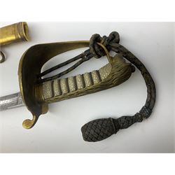 WW1 George V era 1827 Pattern Royal Naval Officer’s sword, the 80cm fullered steel blade decorated with crown, fouled anchor etc and marked Gieves Portsmouth London Edinburgh Devonport to the ricasso, gilded hilt with fouled anchor and crown, wire-bound ray skin grip, lion’s head pommel with mane backstrap, folding/locking langet and full bullion knot; in  leather scabbard having twin brass lockets with hand engraved panels and twin suspension rings L94cm overall. Provenance: By direct family descent from Brian Heathcote HMS Conqueror later Superintendant in the Liverpool Special Constabulary.