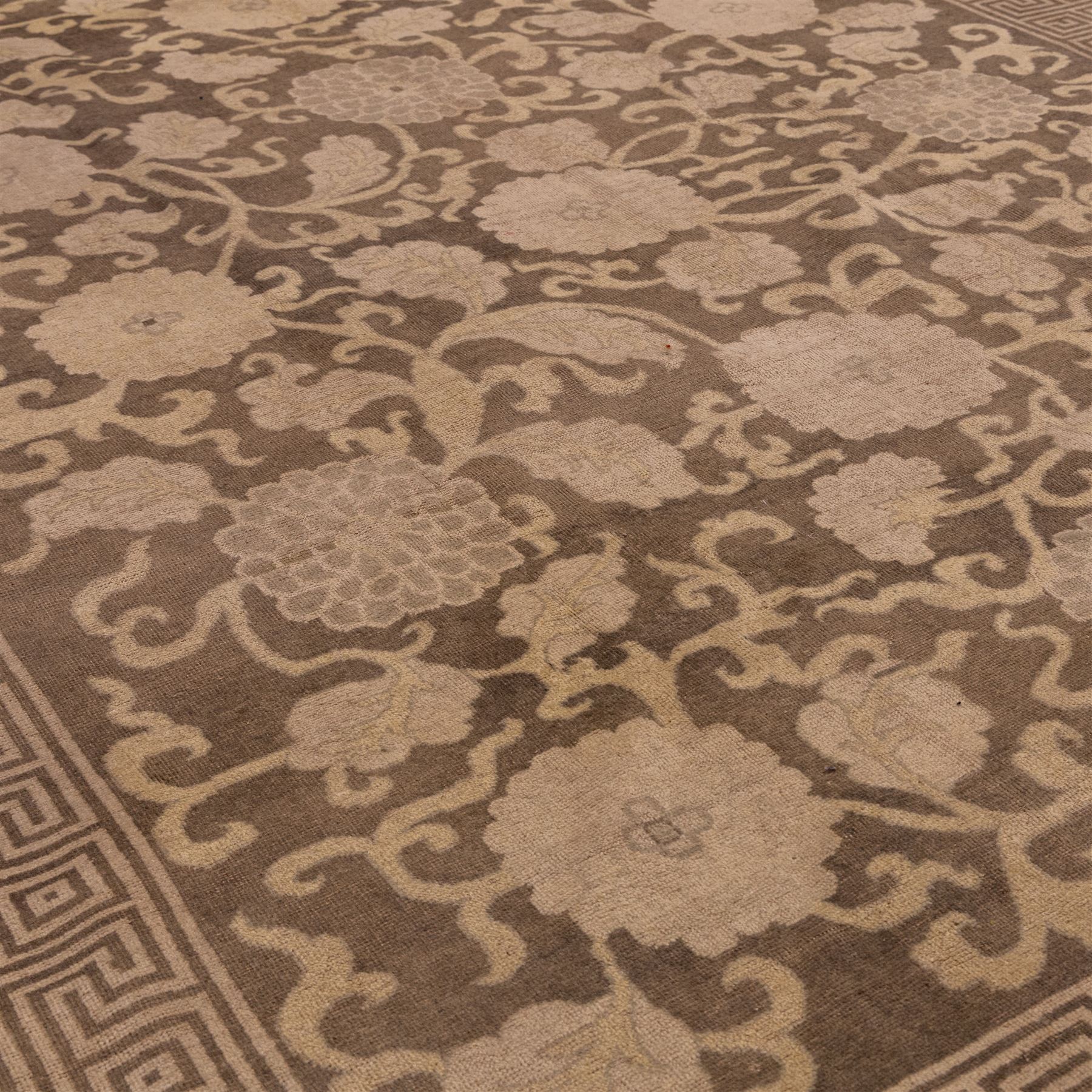 Indian Khetar hand knotted carpet, the brown ground decorated with an all over scrolling foliate and palmette design, enclosed within a conforming floral border with guard stripes