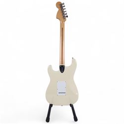 Fender Stratocaster electric guitar, serial no. P093223 made in Japan c.1993, with cream body, white scratch plate, maple neck, three pickups, three control dials and five way selector switch, in a black Fender USA hardcase, guitar L99cm