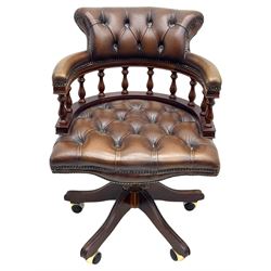 Mahogany framed swivel Captains desk chair, upholstered in brown buttoned leather, turned supports and swivel base on castors