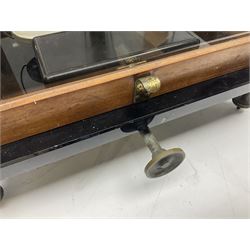 Set of laboratory balance scales by Reynolds & Branson of Leeds in fully glazed mahogany case with rise-and-fall front door, black vitrolite base with brass feet and hand cranked action L40cm H51.5cm D30cm; and bakelite cased set of brass weights