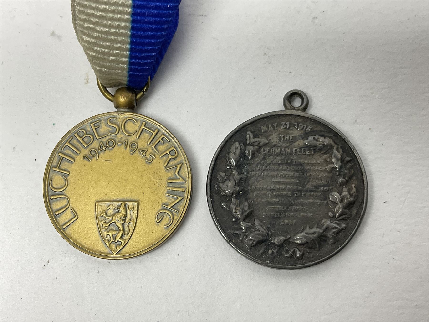 RMS Lusitania iron medallion dated 5th May, 5.5cm diameter, boxed with St Dunstan's Blinded Soldiers Profit paperwork; another unboxed similar Lusitania medallion; 30th Corps Alamein Cuxhaven medallion; Battle of Jutland 1916 silver memorial pendant; Navajo Code Talkers medallion 2000; and five other military related medallions