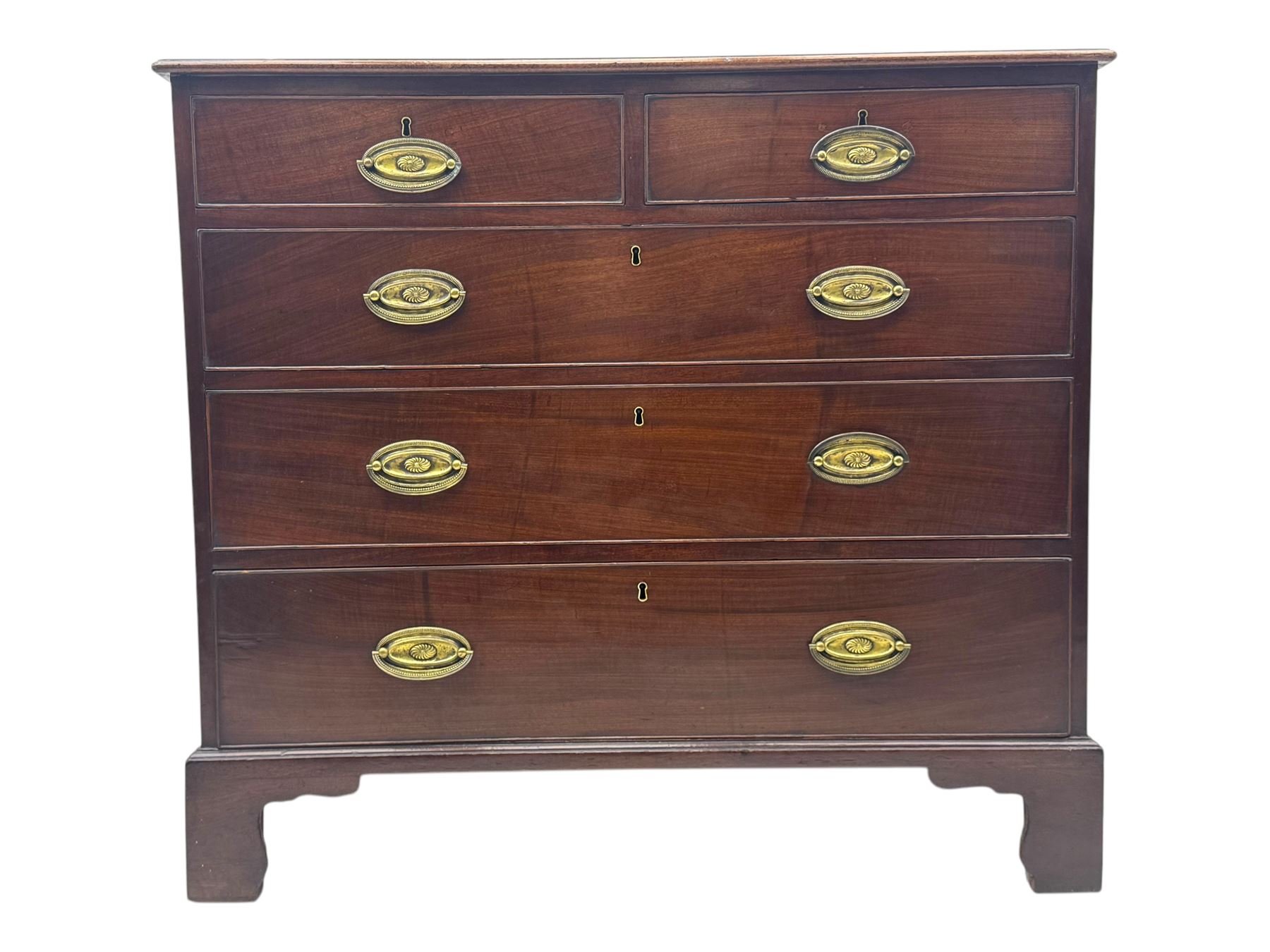 George III mahogany chest, rectangular top with moulded edge over two short and three long graduated cockbeaded drawers, each fitted with brass oval handles, on bracket feet