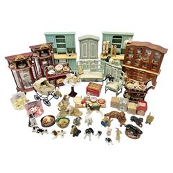 Collection of miniature dolls house furniture, to include display cabinet with pink and white floral dinner service, two serving trolleys with cakes and sweets and two blue painted kitchen dressers, together with miniature dolls house cardboard food packaging and animal figures including dogs and cats, etc