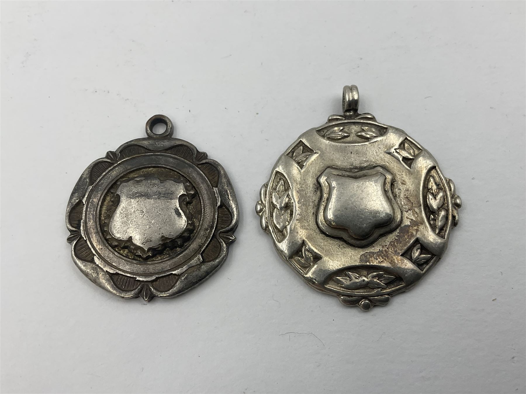 Ten early 20th century silver cartouche fobs, to include a Yorkshire Rose example, all hallmarked with various dates and makers
