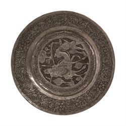 Set of four Persian silvered copper plates, decorated in relief, the central panel depicting figures in various scenes with a floral boarder, D17cm