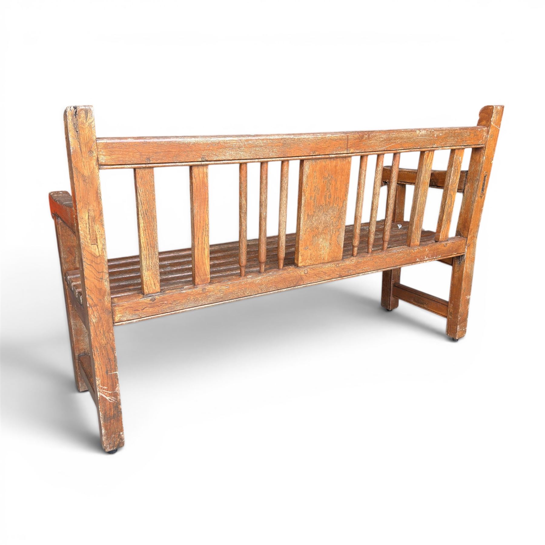 20th century teak cricket bench featuring a central splat with moulded cricket bat and ball motif flanked by stylised wicket spindles, over a slatted seat and square supports