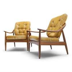 Greaves & Thomas - pair of mid-20th century light elm framed lounge armchairs, with downswept arms and a spindle back, webbing base with makers mark, tan brown leather seat cushions with button back detail
