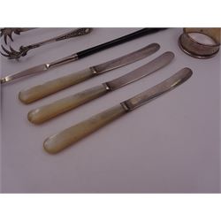 Group of silver, comprising toddy ladle, inset with Spanish coin and with baleen twist handle, three mother of pearl handled butter knives, a Yard-O-Led pencil and a collection of flatware, including pair of sugar tong with claw bowls