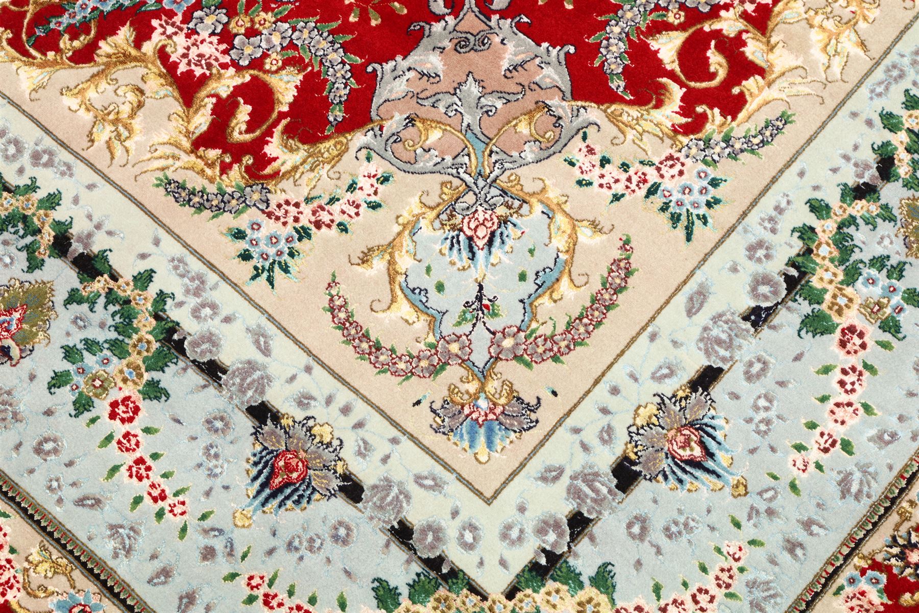 Fine Persian silk inlaid crimson ground Tabriz rug, the shaped field decorated with a central foliate pole medallion filled and surrounded by finely knotted floral motifs and trailing foliage, the cyan guard stripe with bold festoons and palmette motifs