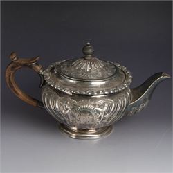 Victorian silver four piece tea service, comprising hot water pot, teapot, milk jug and sugar bowl, of circular part fluted bellied form, with embossed and engraved floral decoration, engraved with initials to body, the teapot and hot water pot with wooden handles and finials, hallmarked Z Barraclough & Sons, Sheffield 1898