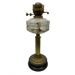Early 20th century brass oil lamp with ornate foliate base and clear glass reservoir, H46cm