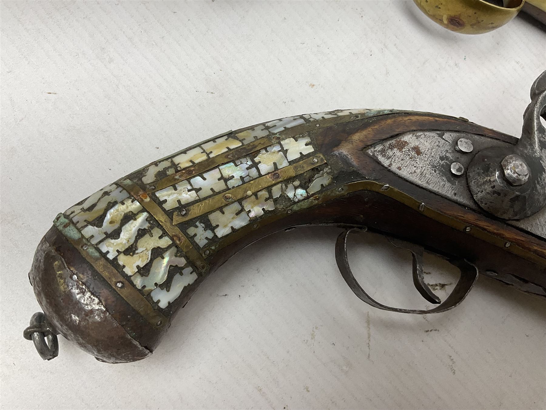 Modern non-firing reproduction Tower flintlock pistol marked with crowned GR and Tower to the lock, brass skull crusher butt and fittings L40cm overall; another Indian/Moorish reproduction flintlock pistol with mother-of-pearl inlay; and a modern die-cast replica Colt style revolver (3)