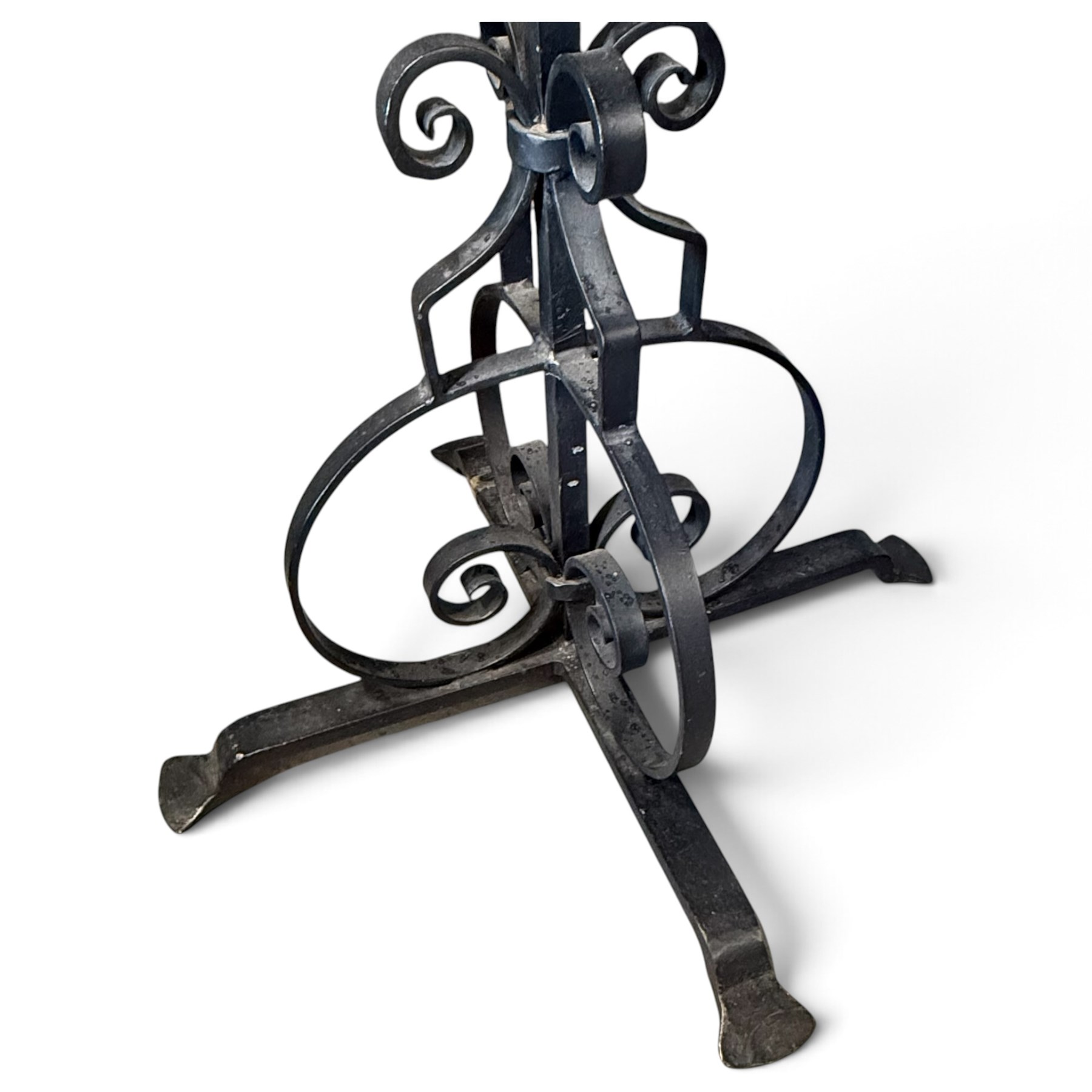 Collection of wrought iron candle stands, comprising five-light and three-light floor-standing candelabra with scrolling branches, and a pair of five-light table candelabra of naturalistic branching form