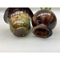 Linthorpe pottery vase with crimped rim and ovoid body, Linthorpe jug with high loop handle and crimped spout, a pair of candlesticks with a green, brown glaze and other similar pottery 