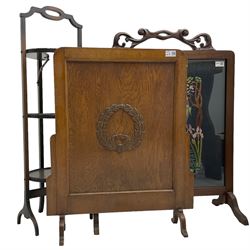Early 20th century mahogany framed fire screen with needlework panel (W64cm); early 20th century oak fire screen (W57cm); and an early 20th century mahogany three tier cake stand (H89cm) (3)