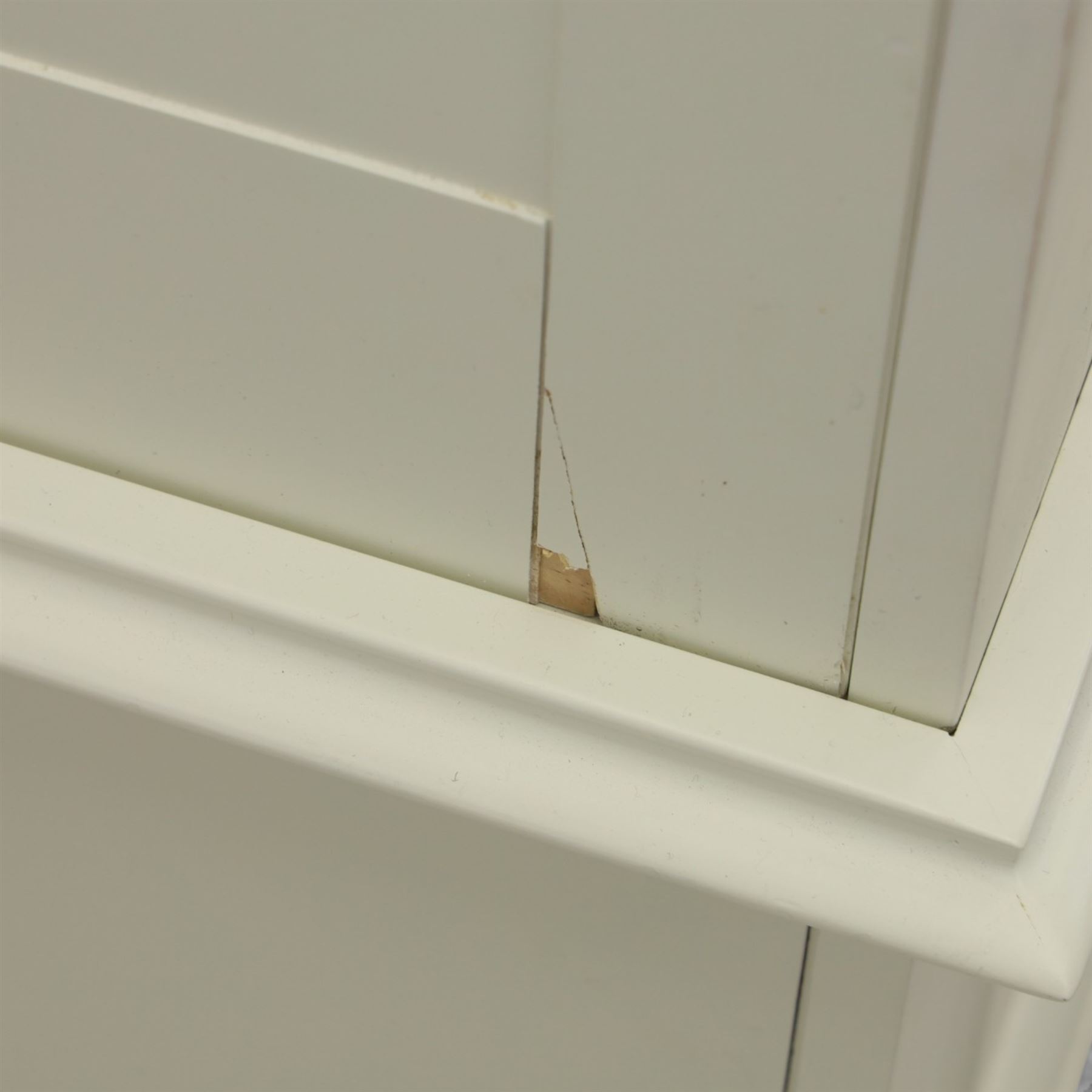Modern white three door wardrobe, with two hanging section and shelving area, above a long drawer and a short drawer to the base, raised on a moulded plinth