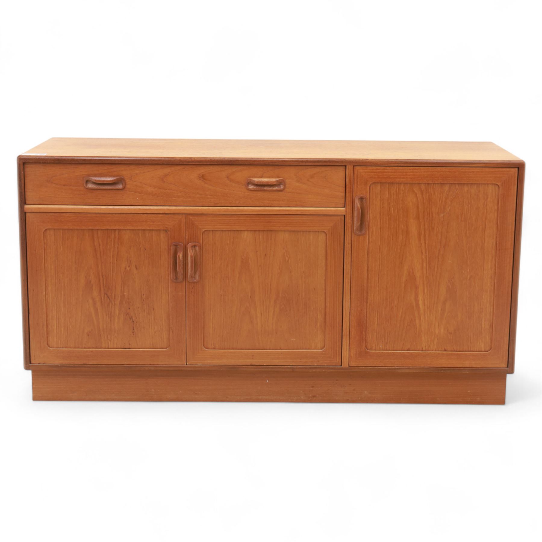 G Plan - Mid-20th century teak sideboard, fitted with single drawer above three cupboard doors, recessed handles throughout, raised on a plinth base