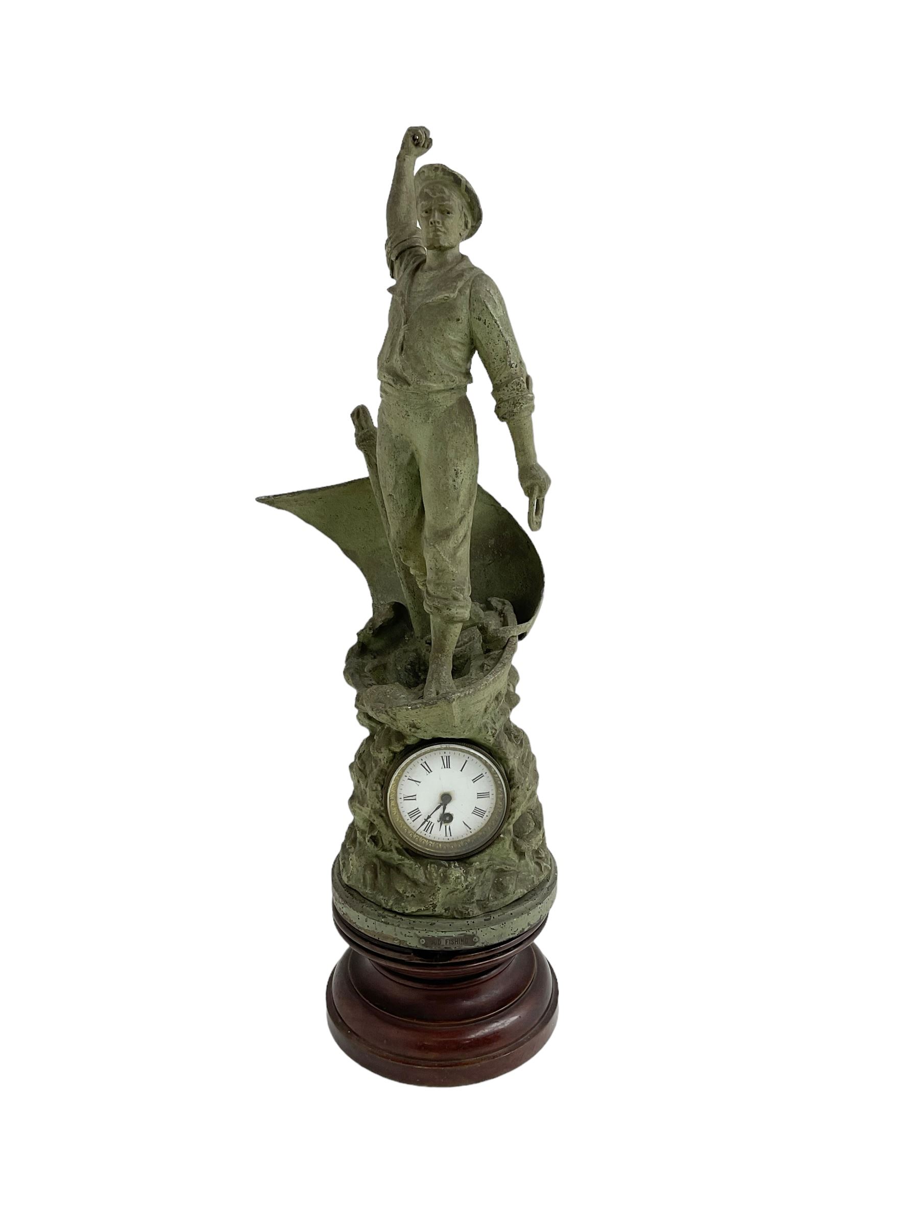 Edwardian - Large figural clock with a Verdigris finish mounted on a mahogany plinth, detailed depiction of a fisherman in a sailing boat entitled 