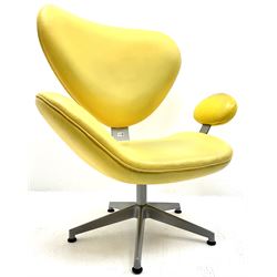 Retro style shaped chair upholstered in a yellow material, metal frame, five spoke supports 