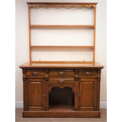  Early 20th century oak dresser, three tier plate rack, four drawers, two cupboard doors, plinth base, W140cm, H197cm, D50cm  
