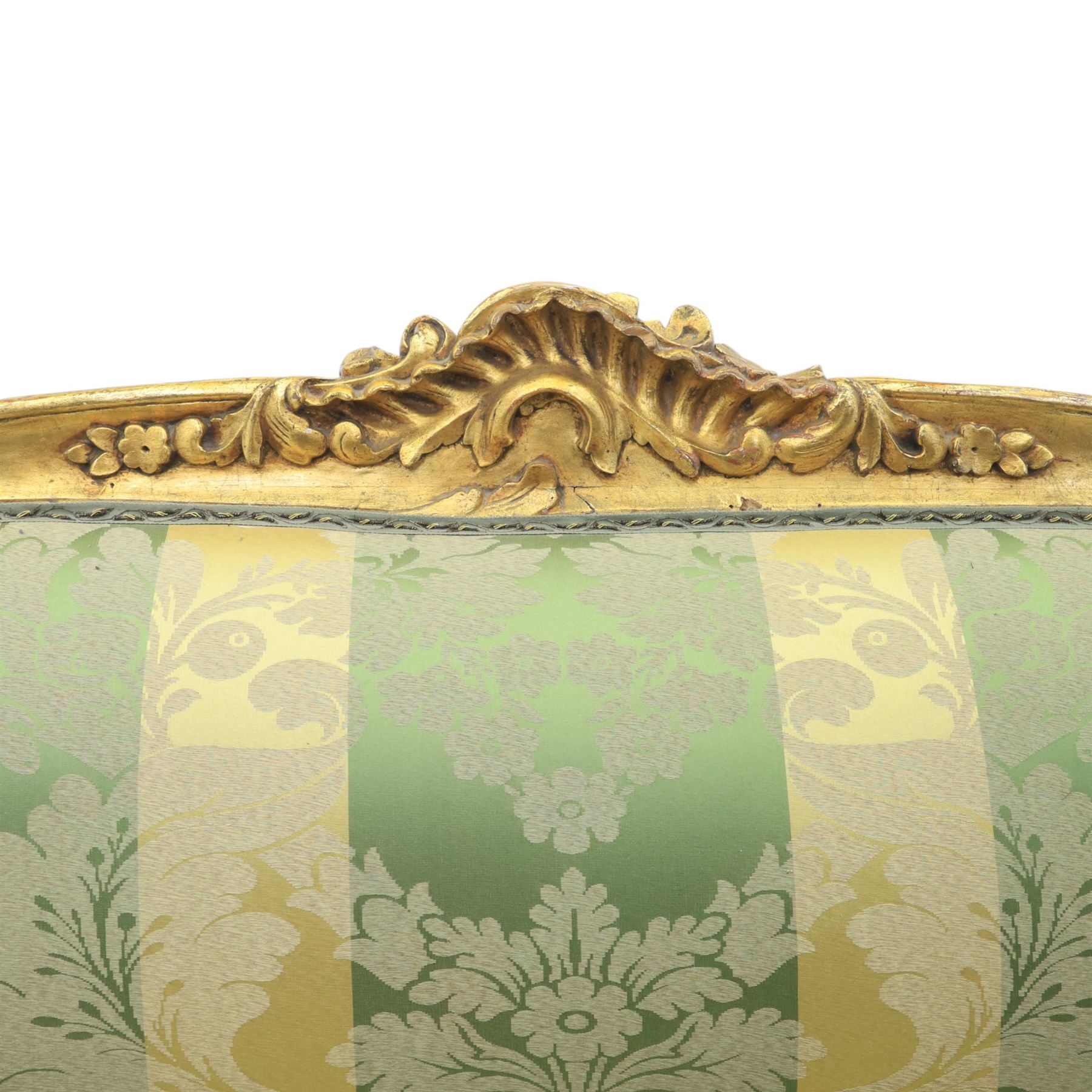 20th century French Louis XV style giltwood salon sofa, with shaped and moulded serpentine cresting rail carved with central scroll motif, padded back and seat upholstered in green and gold striped damask fabric, scroll carved open arms with padded rests, shaped apron carved with rocaille and foliate motifs, raised upon cabriole legs