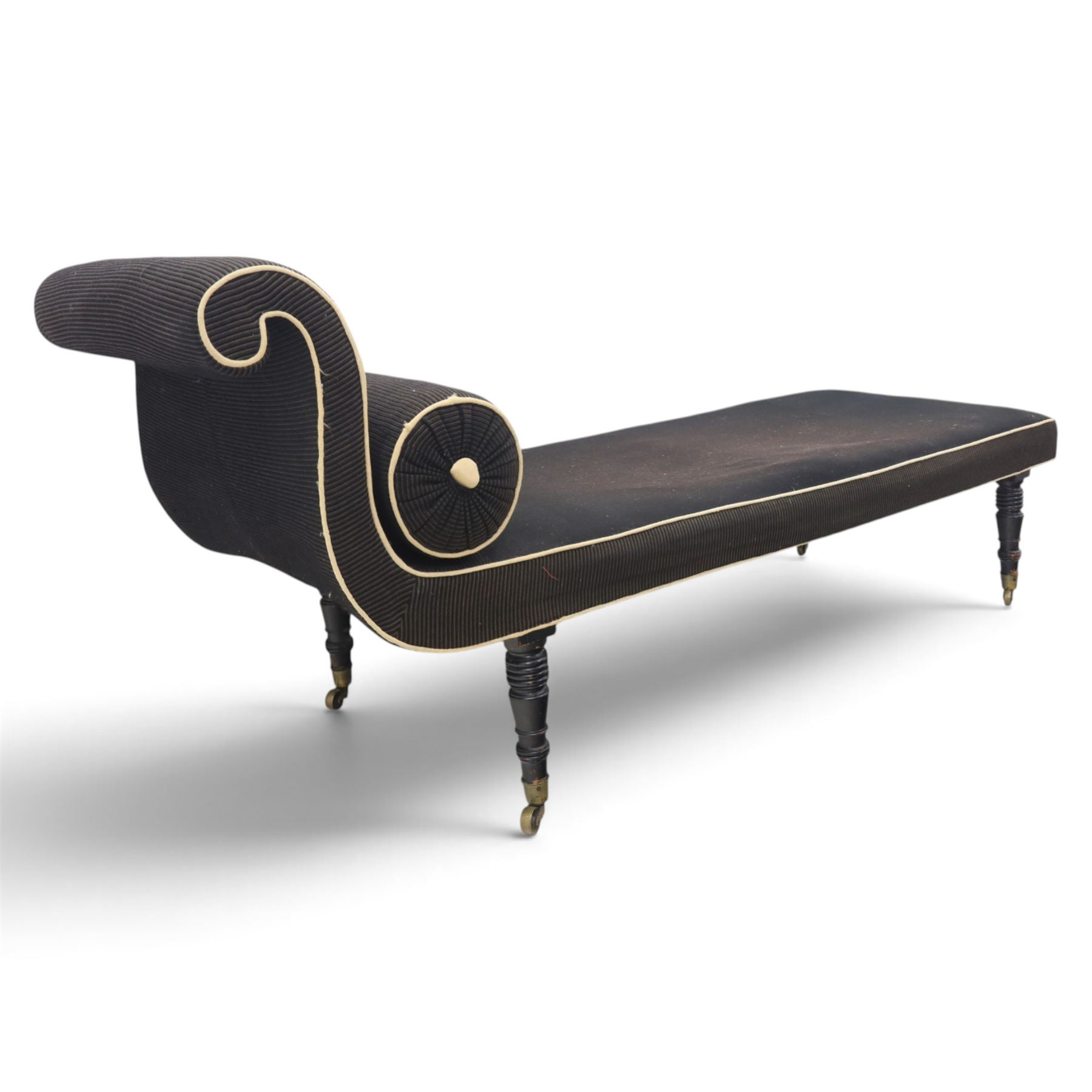 Victorian ebonised chaise longue, upholstered in black fabric with scroll headrest and bolster cushion, rectangular seat with rounded corners, raised on turned supports terminating in brass and ceramic castors