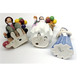Royal Copenhagen figure of a young girl holding a doll and two Royal Doulton figures: Biddy Penny Farthing and The Balloon Man (3)