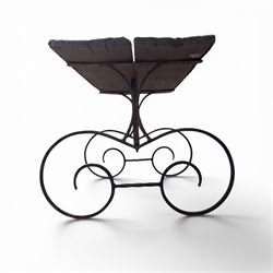 Cast iron garden table, with rectangular weathered slatted wooden top, raised on iron strapwork supports of scrolling form, in black painted antique finish 