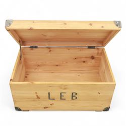 Pine storage trunk, of rectangular plank construction with metal corner protectors and stencilled lettering ‘LEB’ to front and lid