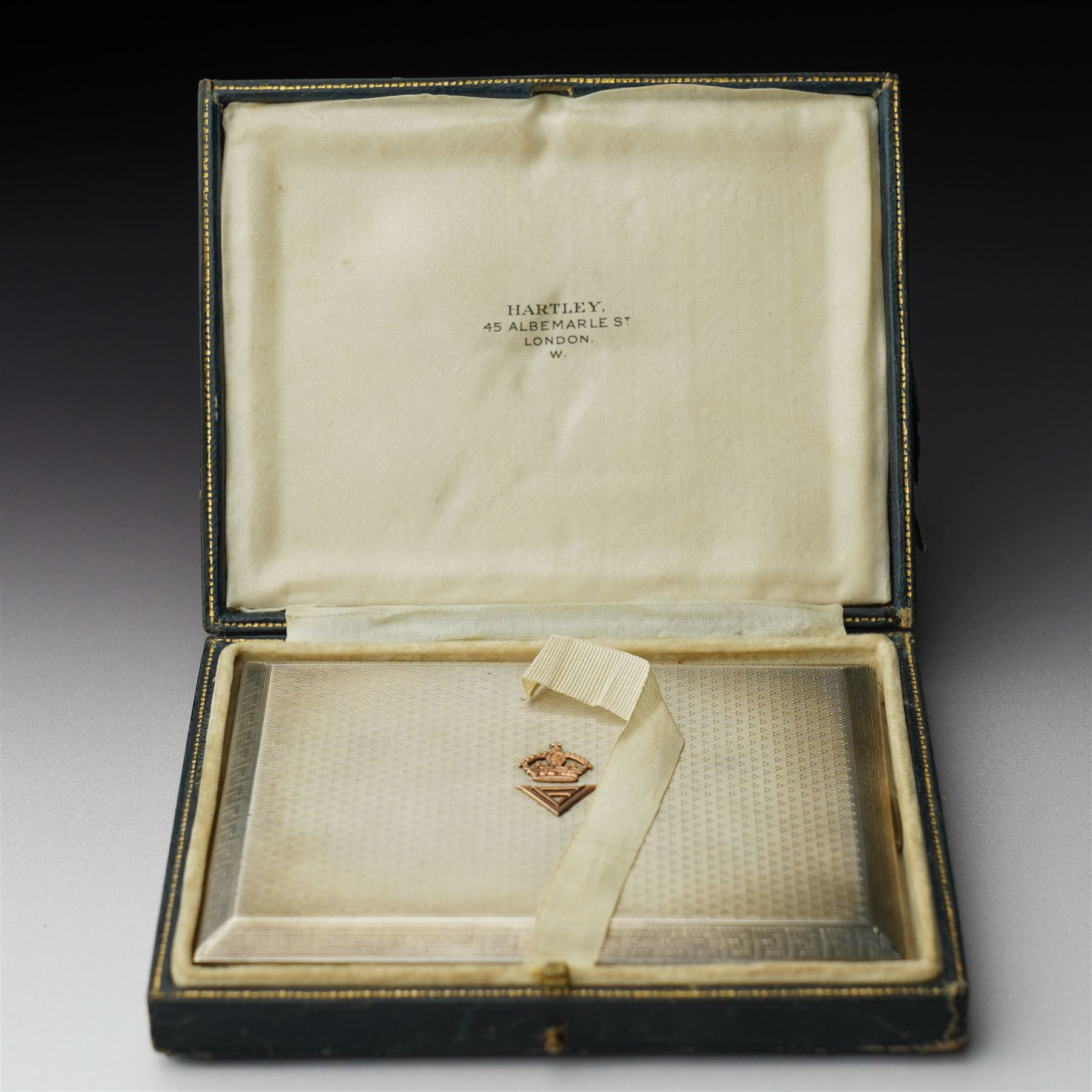 Royalty Interest - Engine turned silver cigarette case with gold crowned cypher, the gilded interior with a greetings card signed 'Edward' and an Egyptian cigarette 11cm x 8cm Birmingham 1925 Maker Adie Bros. Ltd in the original gilt tooled leather case marked 'Hartley, 45 Albemarle St., London'