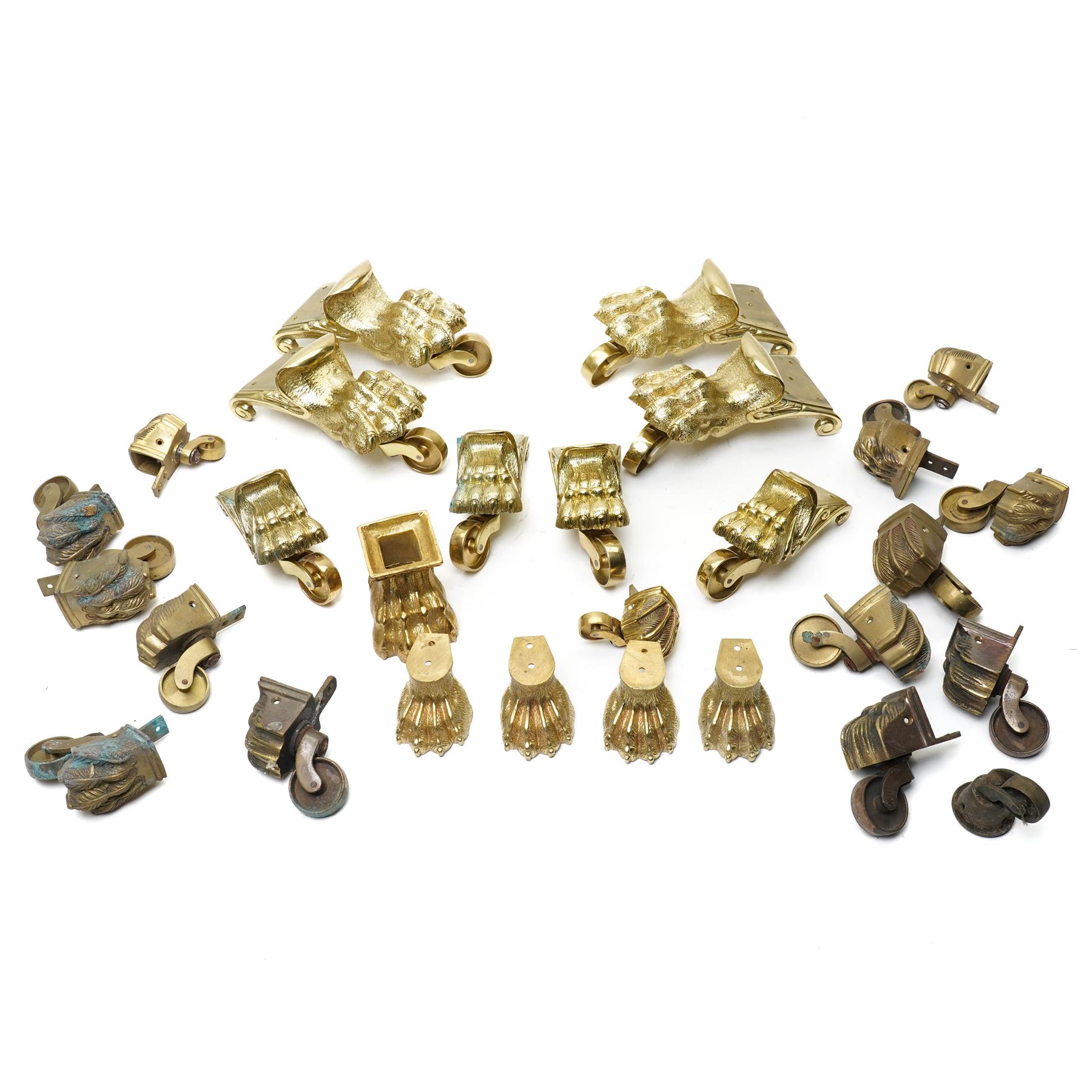 Set of four period design lacquered brass paw furniture castors by Beardmore, London, set of four matching smaller castors and a quantity of various brass castors   
Provenance: property of a Nobleman