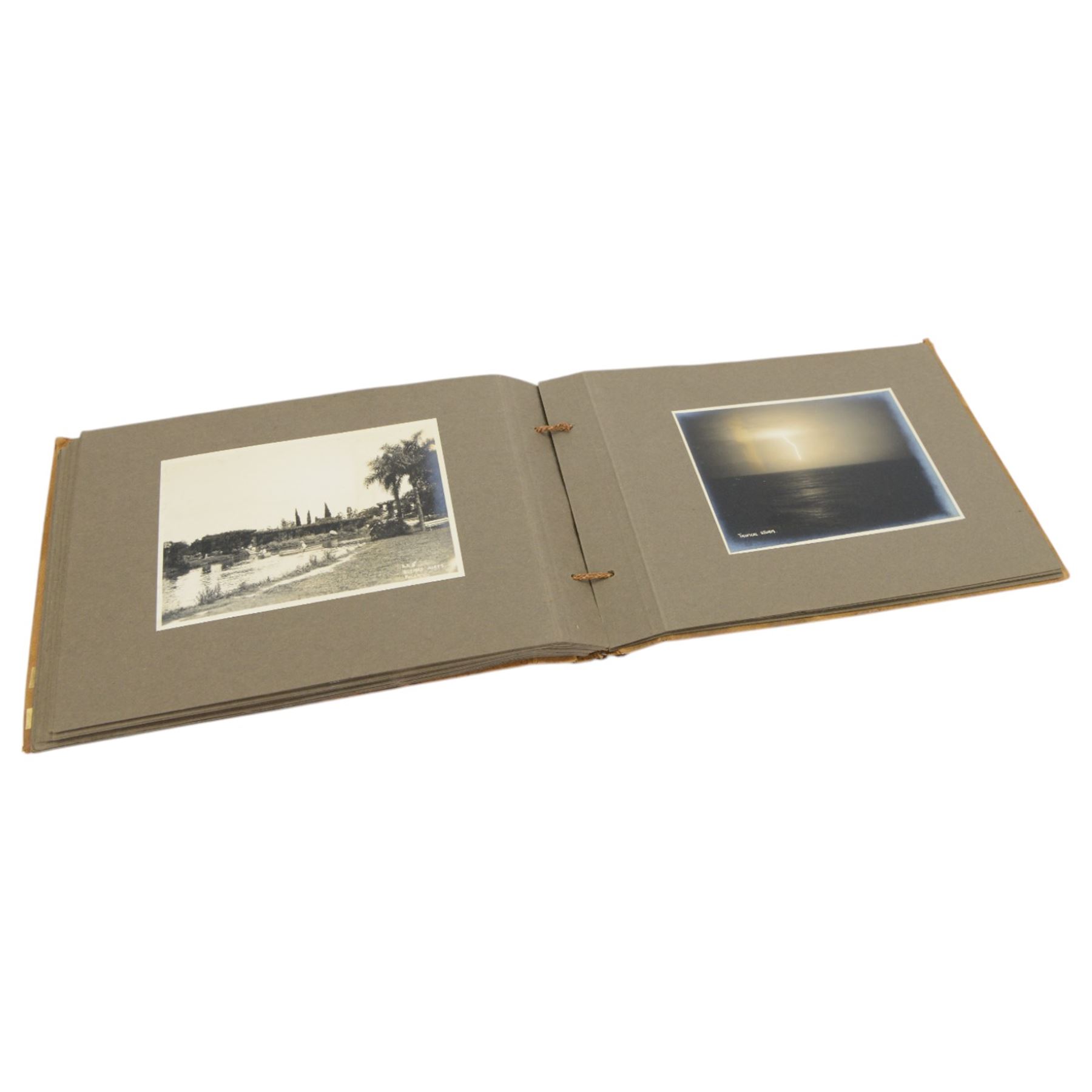 Early 20th century photograph album, documenting the travels of RMS Alcantara, with painting to front cover and containing black and white photographs