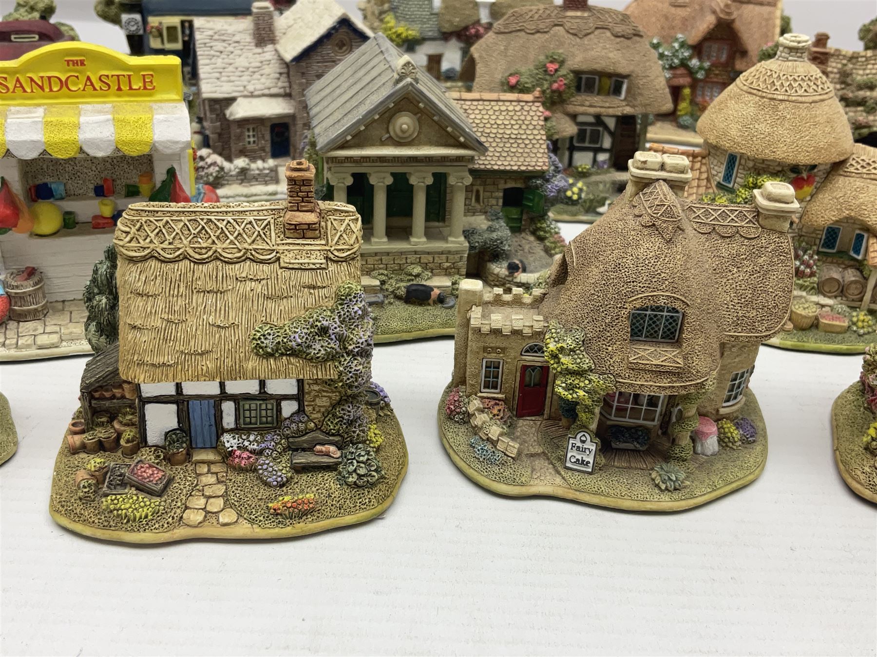 Eighteen Lilliput Lanes, including The Penny Farthing, The Pigsty, Borrowdale School, Fairy Cake Tearoom, An Apple a Day,Ladybird Cottage etc, all with original boxes 