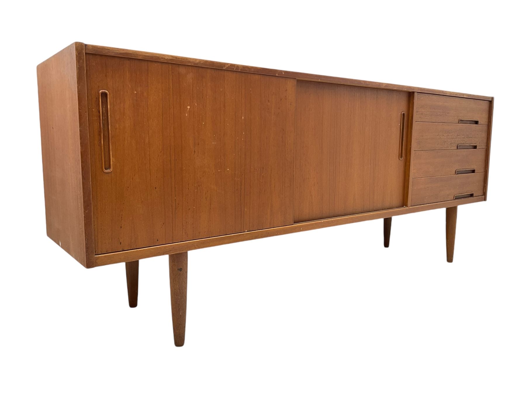 Nils Jonsson - mid-20th century teak sideboard, rectangular top over three-section base, left and centre sections with sliding double doors enclosing shelving, right section with four drawers, raised on tapered supports