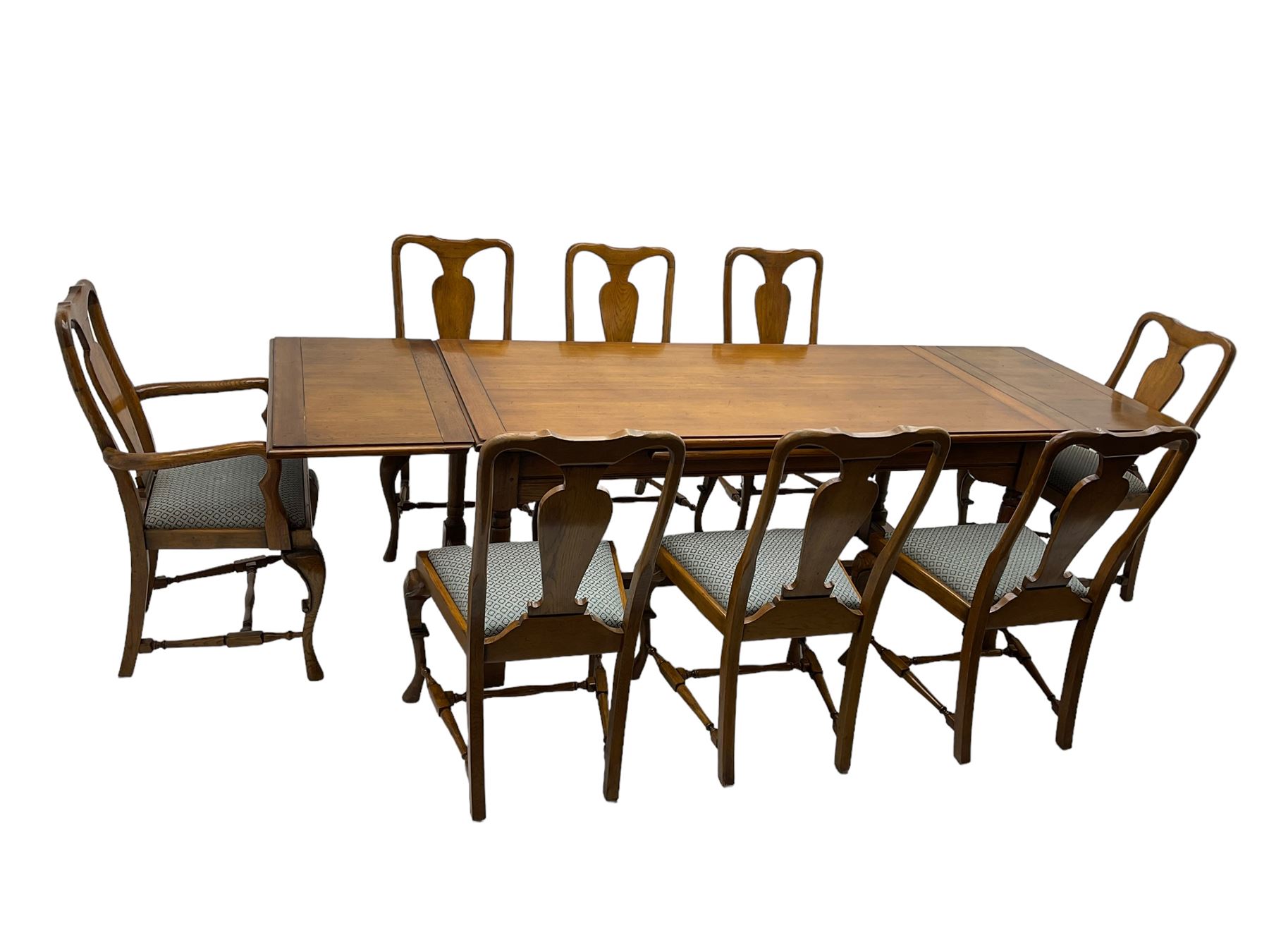 Late 20th century oak dining table, rectangular top with two draw leaf extensions, on turned supports united by moulded hayrake stretchers (180cm - 278cm x 90cm, H76cm); set of eight (6+2) oak dining chairs, shaped cresting rail over shaped splat back, upholster drop-in seat, on cabriole supports united by turned H-shaped stretchers 